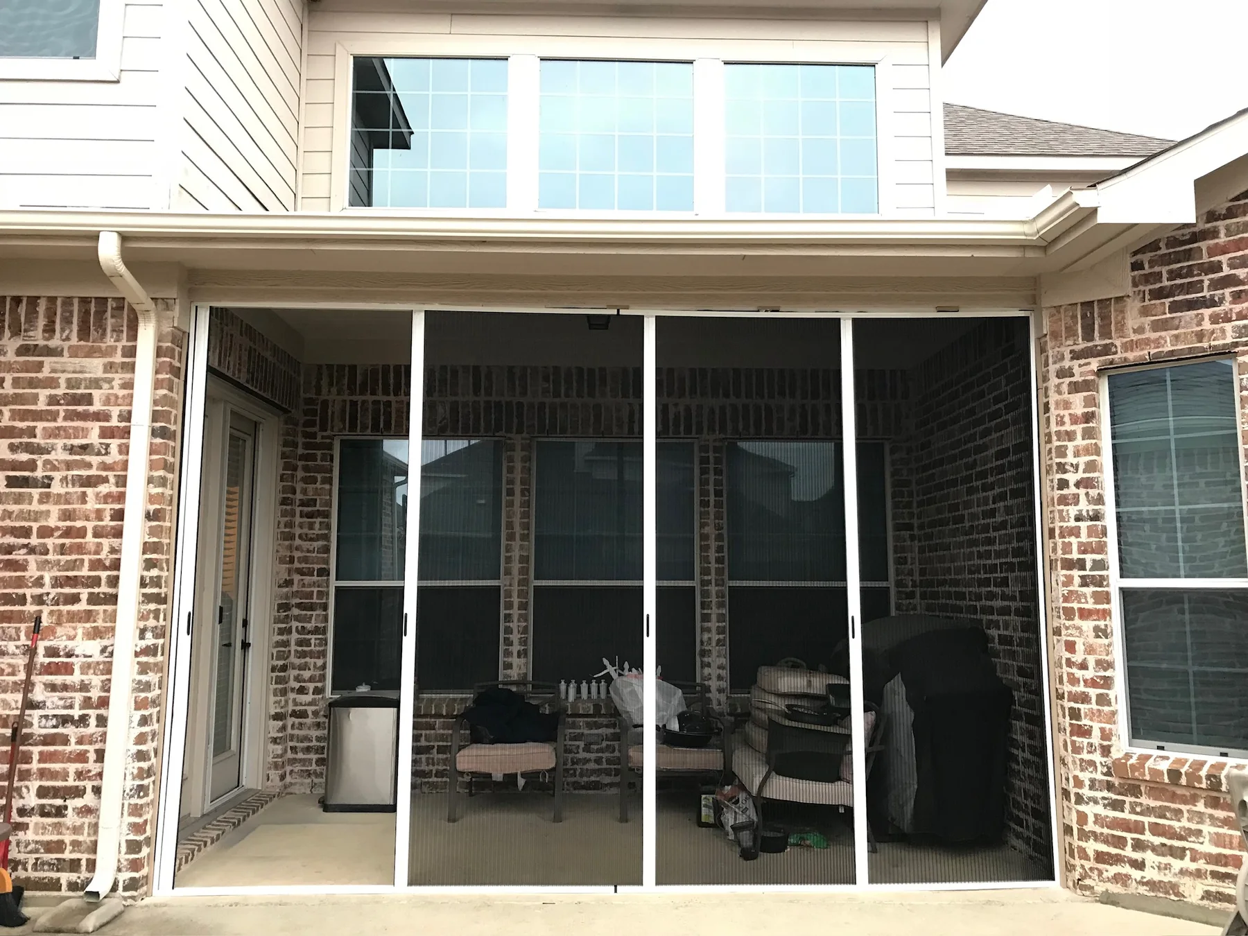 Front view of a multi-handle patio screen installation