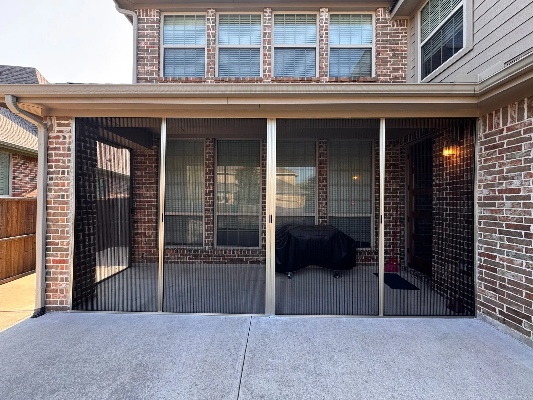 Exterior view of a patio enclosed with pleated screens