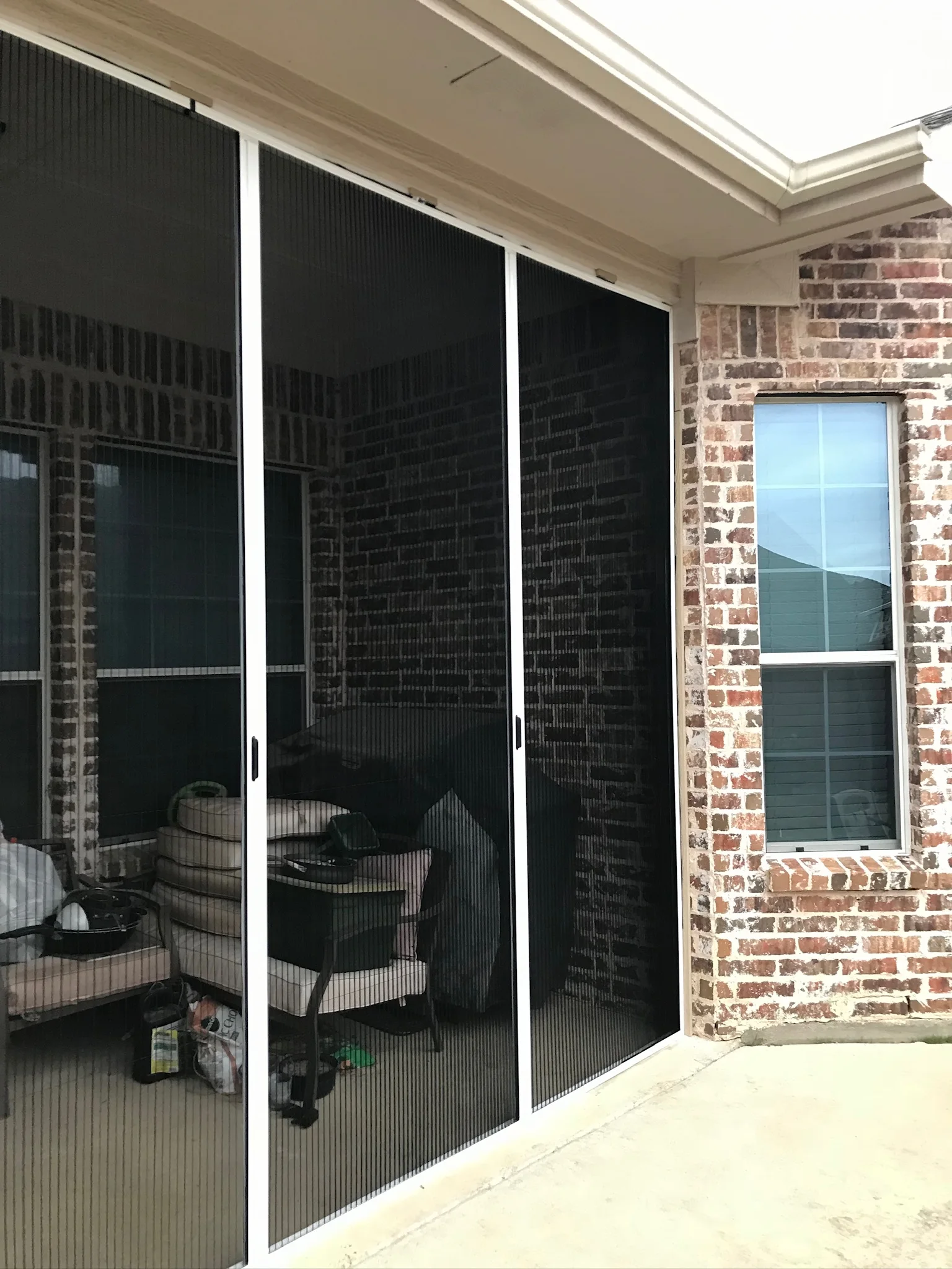 Vertical handles on a wide patio screen opening